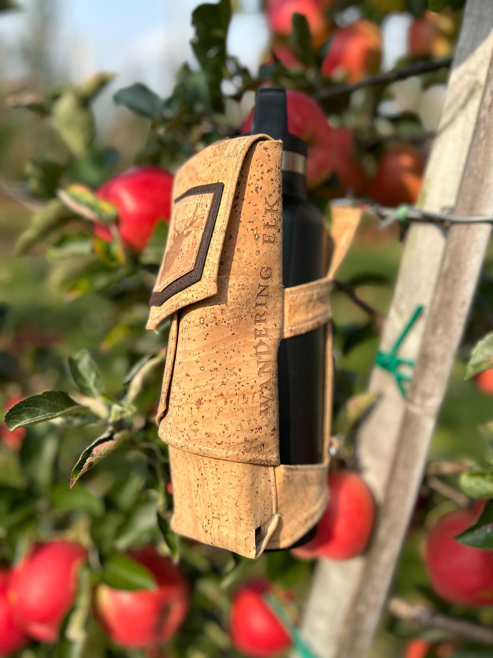 Wandering Elk bottle harness in an orchard